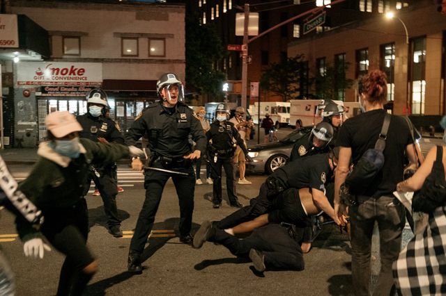 NYPD officers tackle a protester at a demonstration on May 31st in NYC.